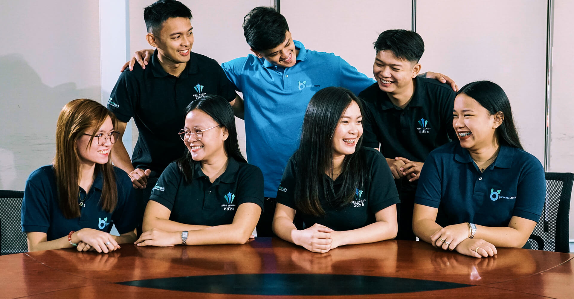 Beyond Limits team members collaborating and sharing a light moment during a meeting